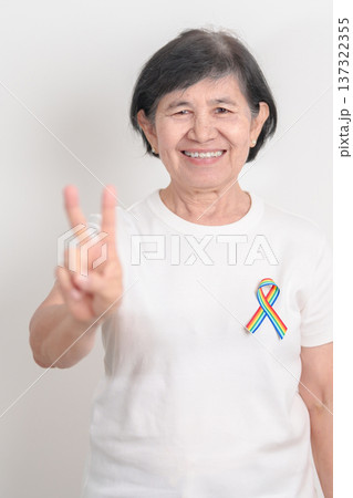 Elderly with LGBTQ Rainbow ribbon for concept of June Pride month, April Autism Awareness, All cancer Awareness, February World Cancer day, October World Hospice and Palliative care day and Survivor Elderly with LGBTQ Rainbow ribbon for concept of June Pride month, April Autism Awareness, All cancer Awareness, February World Cancer day, October World Hospice and Palliative care day and Survivor 137322355