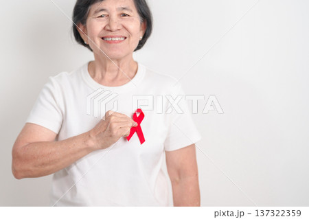 Elderly with Red Ribbon for December World Aids Day, MADD, October Red ribbon week, February Heart month, Marfan Syndrome, May Stroke awareness, March world TB Tuberculosis day and April Dare day 137322359