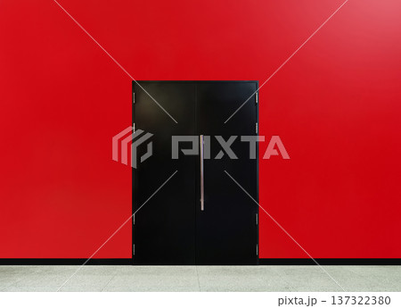 A black iron door on a red cement wall. A black iron door on a red cement wall. 137322380