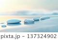 Smooth stones on serene beach with soft waves and pastel hues create tranquil atmosphere 137324902