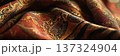 Richly detailed close up of luxurious patterned fabric with warm tones and intricate designs 137324904