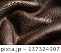 Richly textured close up of brown leather fabric with natural folds and fine details 137324907