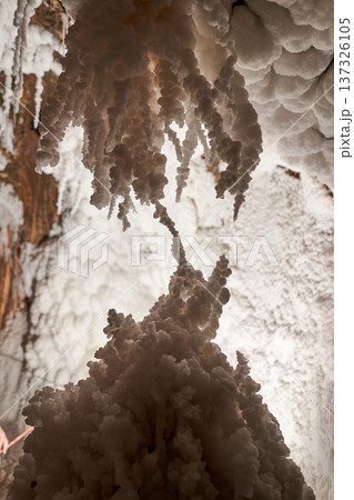 A stunning view of an underground cavern showcases unique formations made of crystals and natural structures, created by the passage of time. 137326105