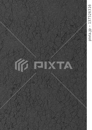 Dark grey asphalt texture with fine surface cracks and weathered stone road details. 137326316