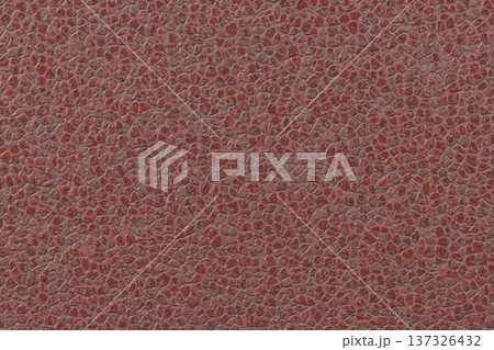 Rough red cracked earth or dry ground texture with dark crevices and uneven surface. 137326432