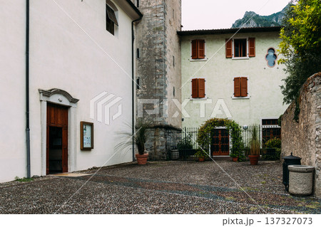 Picturesque church courtyard in Limone sul Garda, Italy, with traditional architecture. Picturesque church courtyard in Limone sul Garda, Italy, with traditional architecture. 137327073