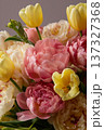Pink and yellow floral arrangement with blooming peonies and tulips embodying spring and celebration 137327368