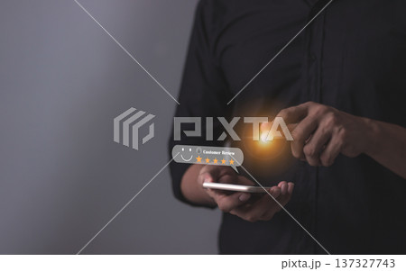 Customer Review, Young Man hand holding Smart Phone with five star to review and give 5 stars with very good results in service, Good review 5 star rating choice feedback 137327743