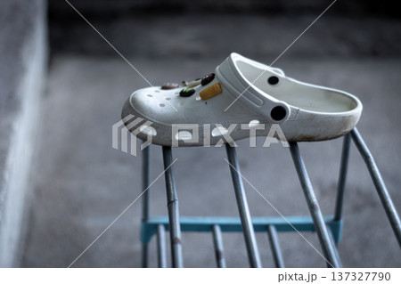 Single shoe left on a shelf symbolizes loss, loneliness, and separation. 137327790