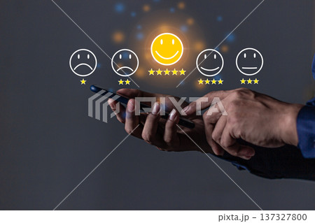 Customer Review, Young Man hand holding Smart Phone with five star to review and give 5 stars with very good results in service, Good review 5 star rating choice feedback 137327800