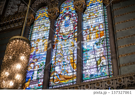 Lyon, france. December 27,2023. Our lady of fourviere basilica stained glass depicting the virgin mary with child amid ornate sacred scenes, colorful light filled panels Lyon, france. December 27,2023. Our lady of fourviere basilica stained glass depicting the virgin mary with child amid ornate sacred scenes, colorful light filled panels 137327861