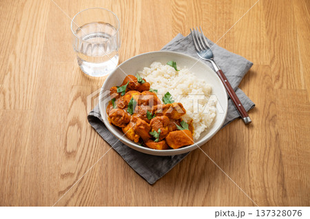 Chicken tikka masala curry with rice on wooden background Chicken tikka masala curry with rice on wooden background 137328076