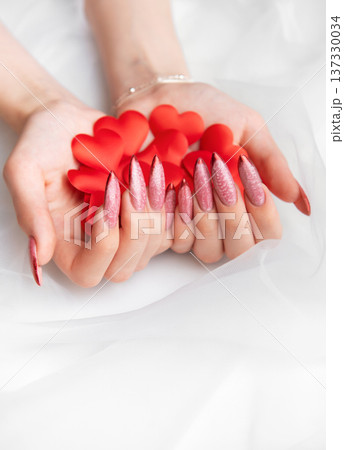 Woman holding red hearts with elegant manicure nails Woman holding red hearts with elegant manicure nails 137330034