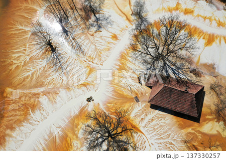Sinking house in the ghost village of Geamana, Romania, choked of toxic mining residuals, aerial view Sinking house in the ghost village of Geamana, Romania, choked of toxic mining residuals, aerial view 137330257
