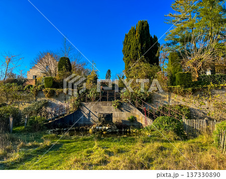 A scenic view of an abandoned hillside with blue sky and old garden 137330890
