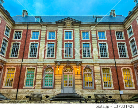 Charming red brick and white stone house illuminated at night with courtyard Charming red brick and white stone house illuminated at night with courtyard 137331429