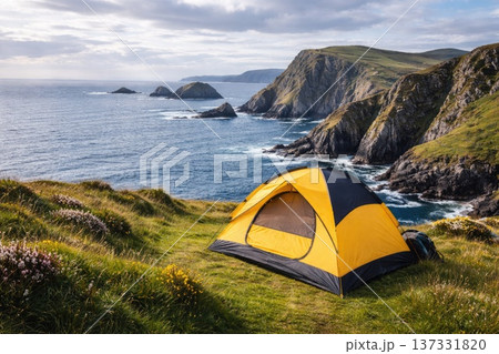 Yellow Camping Tent on Scenic Ocean Cliffs with Dramatic Coastal Landscape 137331820