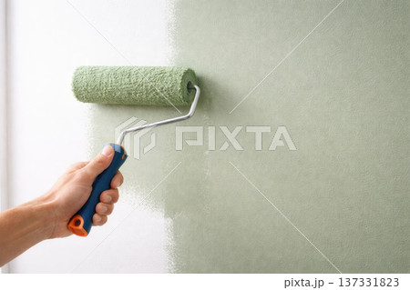 Hand Painting Interior Wall with Green Roller During Home Renovation 137331823