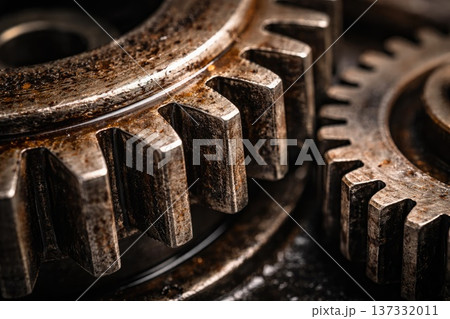 Detailed close up of interconnected metal gears with worn industrial surface Detailed close up of interconnected metal gears with worn industrial surface 137332011