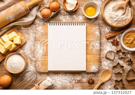 Baking ingredients and utensils arranged around blank recipe notebook on rustic wooden table Baking ingredients and utensils arranged around blank recipe notebook on rustic wooden table 137332027