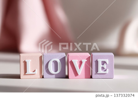 Love word made of pastel wooden blocks with soft romantic lighting Love word made of pastel wooden blocks with soft romantic lighting 137332074