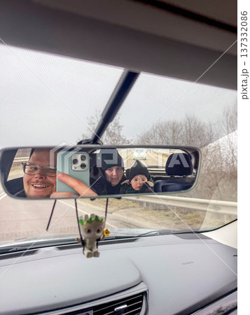 Family selfie reflected in car rearview mirror Family selfie reflected in car rearview mirror 137332086