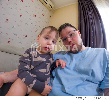 Smiling father and toddler taking a wide-angle selfie at home 137332087