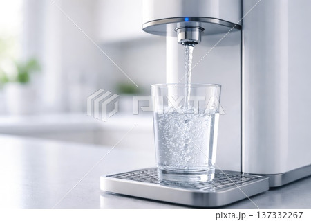 Modern water dispenser filling glass with clean drinking water in bright kitchen interior Modern water dispenser filling glass with clean drinking water in bright kitchen interior 137332267