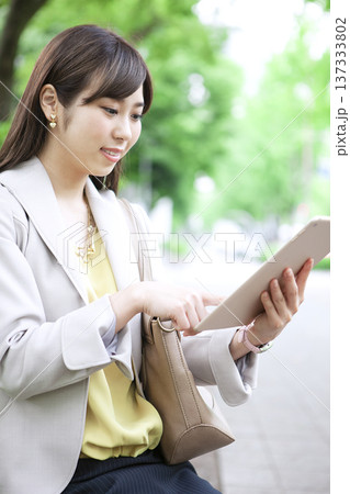 タブレットPCを操作するビジネス ウーマン タブレットPCを操作するビジネス ウーマン 137333802