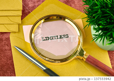 A shimmering magnifying glass rests upon an open yellow envelope, revealing the powerful word limitless 137333942