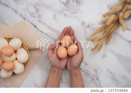 SSTK Easter. Fresh eggs in hands for festive cooking. SSTK Easter. Fresh eggs in hands for festive cooking. 137334084