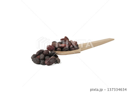 Dogwood or Cornel fruit herb used in herbal medicine on wooden spoon isolated on white background.  Herbs. Alternative medicine. 137334634