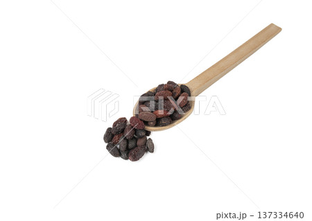 Dogwood or Cornel fruit herb used in herbal medicine on wooden spoon isolated on white background.  Herbs. Alternative medicine. 137334640