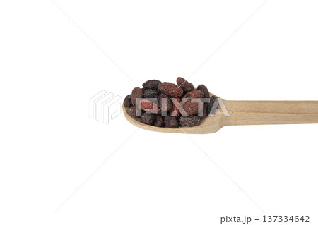 Dogwood or Cornel fruit herb used in herbal medicine on wooden spoon isolated on white background. Herbs. Alternative medicine. Dogwood or Cornel fruit herb used in herbal medicine on wooden spoon isolated on white background. Herbs. Alternative medicine. 137334642