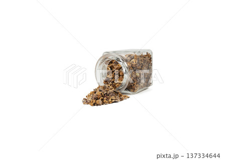 Crataegus, commonly called hawthorn, quickthorn,thornapple, May-tree, whitethorn, Mayflower or hawberry falling from glass jar isolated on white background. Crataegus, commonly called hawthorn, quickthorn,thornapple, May-tree, whitethorn, Mayflower or hawberry falling from glass jar isolated on white background. 137334644