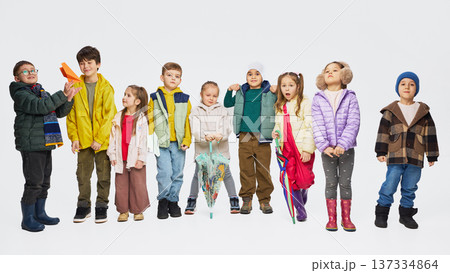 Group of children wearing colorful autumn outfits standing together in studio. Group of children wearing colorful autumn outfits standing together in studio. 137334864