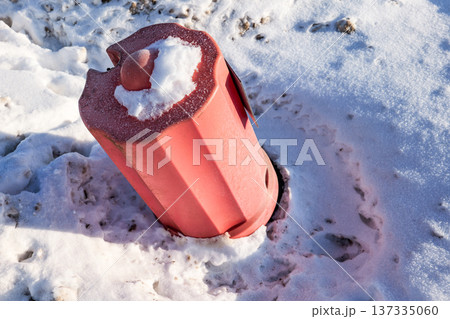 Damaged Fire Hydrant Tilted After Snow Plowing Accident In Winter 137335060