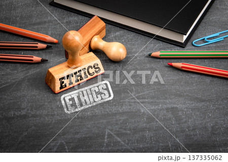 Ethics Concept With Wooden Stamp On Blackboard Workspace Ethics Concept With Wooden Stamp On Blackboard Workspace 137335062