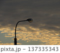 A street lamp on a city street against a background of Dramatic Cloudscape Of Wide Sky with delicate beige and delicate gray stratospheric clouds in a blue sky. Altocumulus 137335343