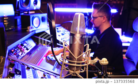 Studio Microphone Ready For Vocal Recording, Producer Controls Mixing Console. Music Production, Professional Sound, Creative Industry, Modern Workspace. 137335568