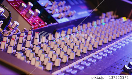 Studio Mixing Console Displays Numerous Knobs And Sliders. Audio Equipment, Music Production, Recording Technology, Creative Industry. Studio Mixing Console Displays Numerous Knobs And Sliders. Audio Equipment, Music Production, Recording Technology, Creative Industry. 137335572
