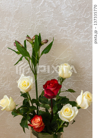 Fresh roses bouquet in glass vase. White and red flowers with green leaves and buds. Elegant home decoration Fresh roses bouquet in glass vase. White and red flowers with green leaves and buds. Elegant home decoration 137335770