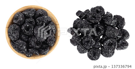 Prunes in wooden bowl isolated on white background, heap of dried plums. Top view. Flat lay Prunes in wooden bowl isolated on white background, heap of dried plums. Top view. Flat lay 137336794