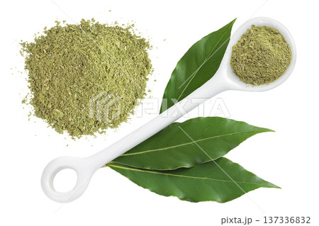 Fresh and ground Laurel leaves in ceramic spoon isolated on white background. Green bay leaf. Top view. Flat lay. Fresh and ground Laurel leaves in ceramic spoon isolated on white background. Green bay leaf. Top view. Flat lay. 137336832