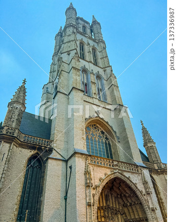 Stunning view of belfry tower and cathedral in historic Ghent under blue skies 137336987