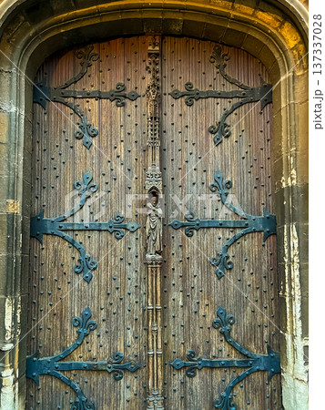 A stunning close-up of an aged wooden church door with detailed ironwork 137337028
