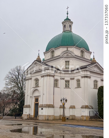 Historic church with green dome located in a town square during cloudy weather Historic church with green dome located in a town square during cloudy weather 137337060