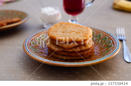 Stacked Potato Pancakes on Rustic Clay Plate Stacked Potato Pancakes on Rustic Clay Plate 137338414