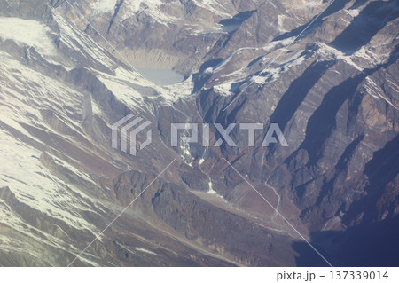 マウンテンフライトの飛行機の窓からのヒマラヤ山脈の山並みの池と山肌の風景 137339014