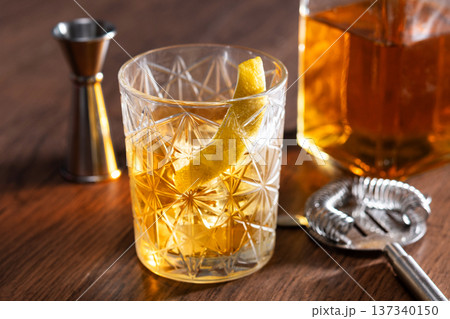 Rusty Nail Cocktail with Lemon Peel in Crystal Glass Rusty Nail Cocktail with Lemon Peel in Crystal Glass 137340150